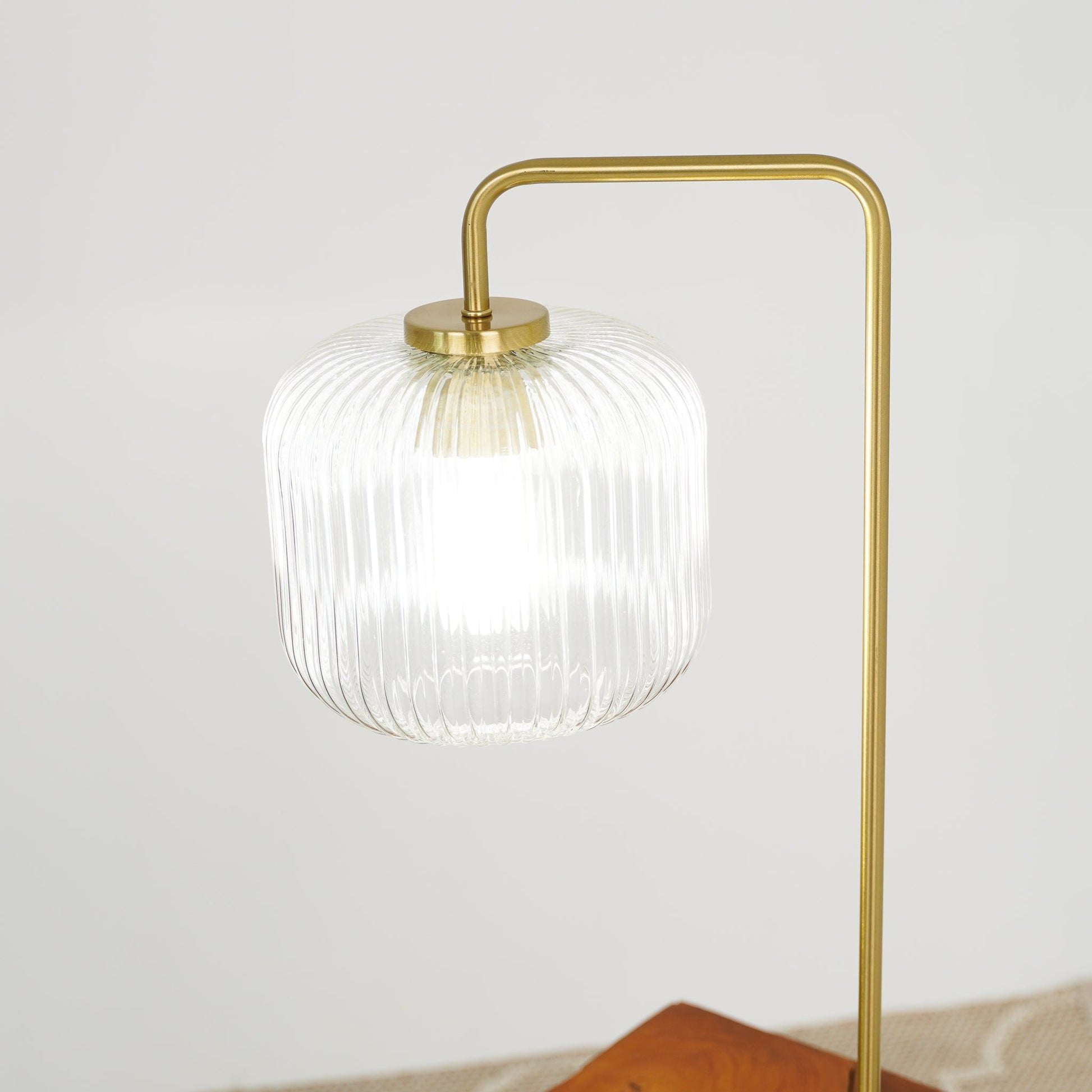 Haven clear ribbed glass table lamp with gold frame and curved top hoop button control on Tampa Home & Garden Store