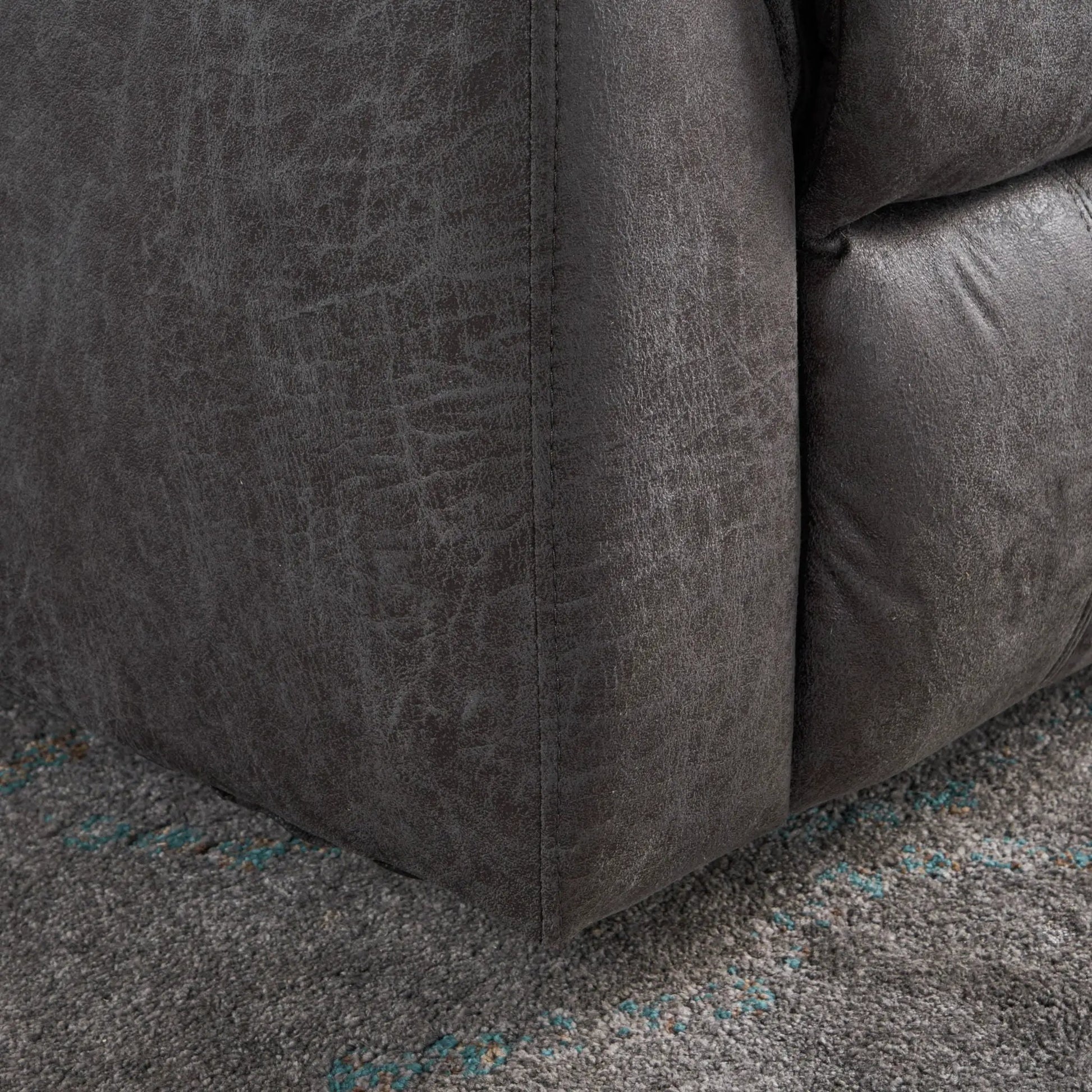 Contemporary glider recliner fabric close-up in dark gray distressed faux leather texture on Tampa Home & Garden Store