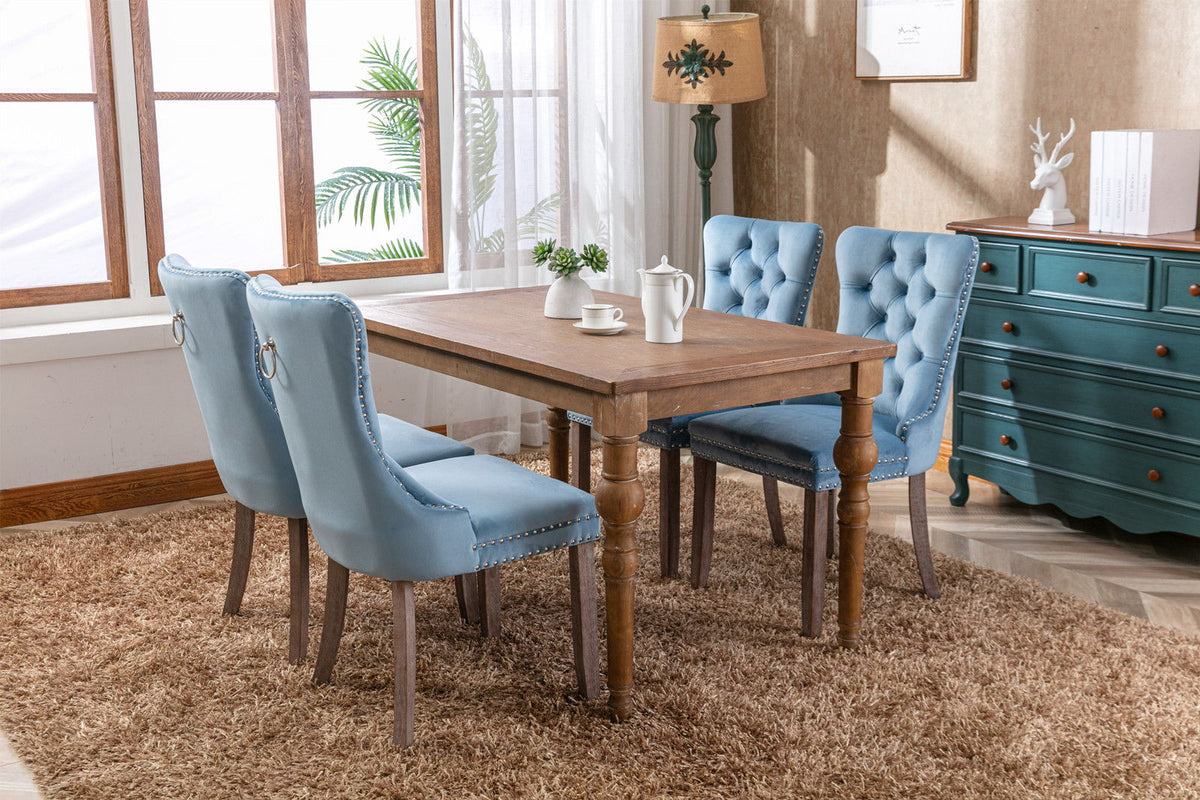 Blue velvet tufted dining chair set with nailhead trim around a rustic wood table, 4 chairs on Tampa Home & Garden Store