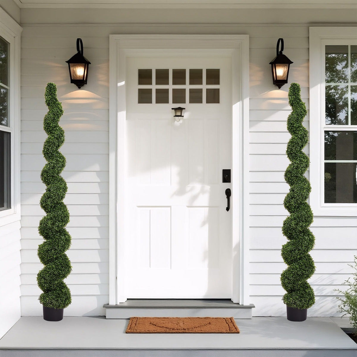Pair of artificial UV-resistant boxwood spiral topiaries in black pots, green foliage on Tampa Home & Garden Store