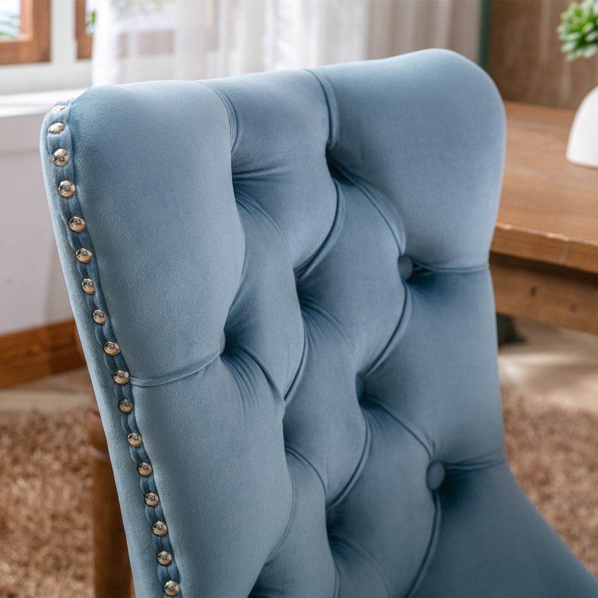 Tufted dining chair set in blue velvet with silver nailhead trim on Tampa Home & Garden Store