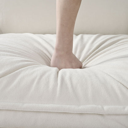 Bare leg resting on a plush white blanket, beige wall backdrop on Tampa Home & Garden Store