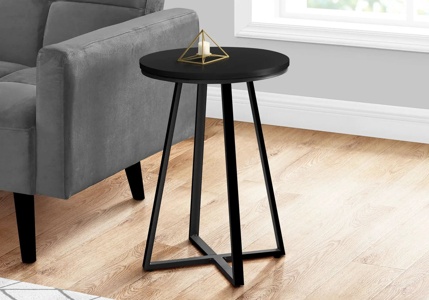 Round black accent table with tripod legs and a gold geometric candle holder on Tampa Home & Garden Store