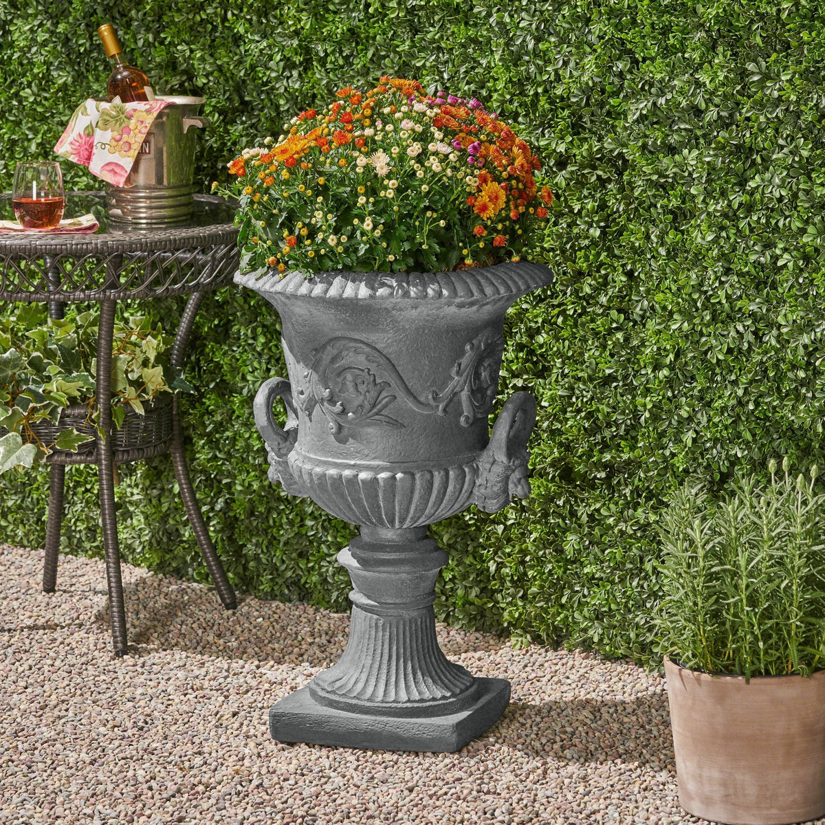 MGO Garden Urn Planter gray stone urn with ornate relief and colorful flowers on Tampa Home & Garden Store