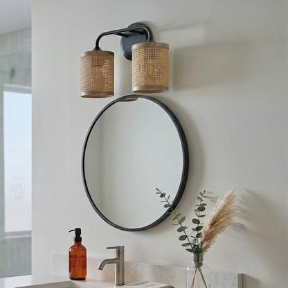 Quell double light vanity wall lamp black with natural rattan shades beside a round mirror on Tampa Home & Garden Store