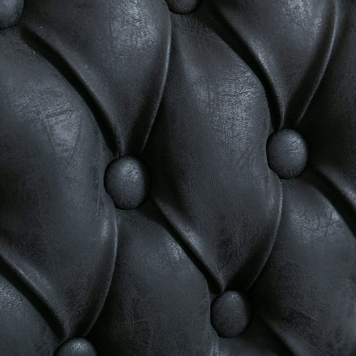 Dining chair close-up in black leather with button tufting on Tampa Home & Garden Store