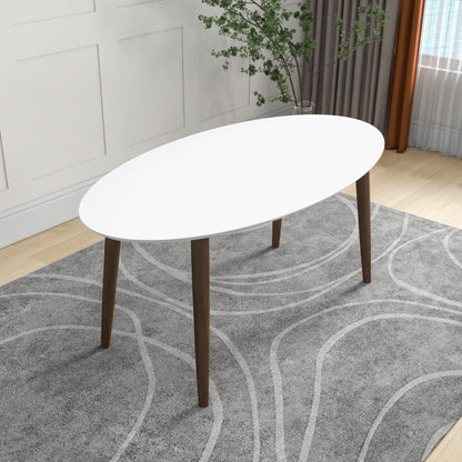 Mid-Century Modern oval dining table in white with solid wood legs in a bright living space on Tampa Home & Garden Store