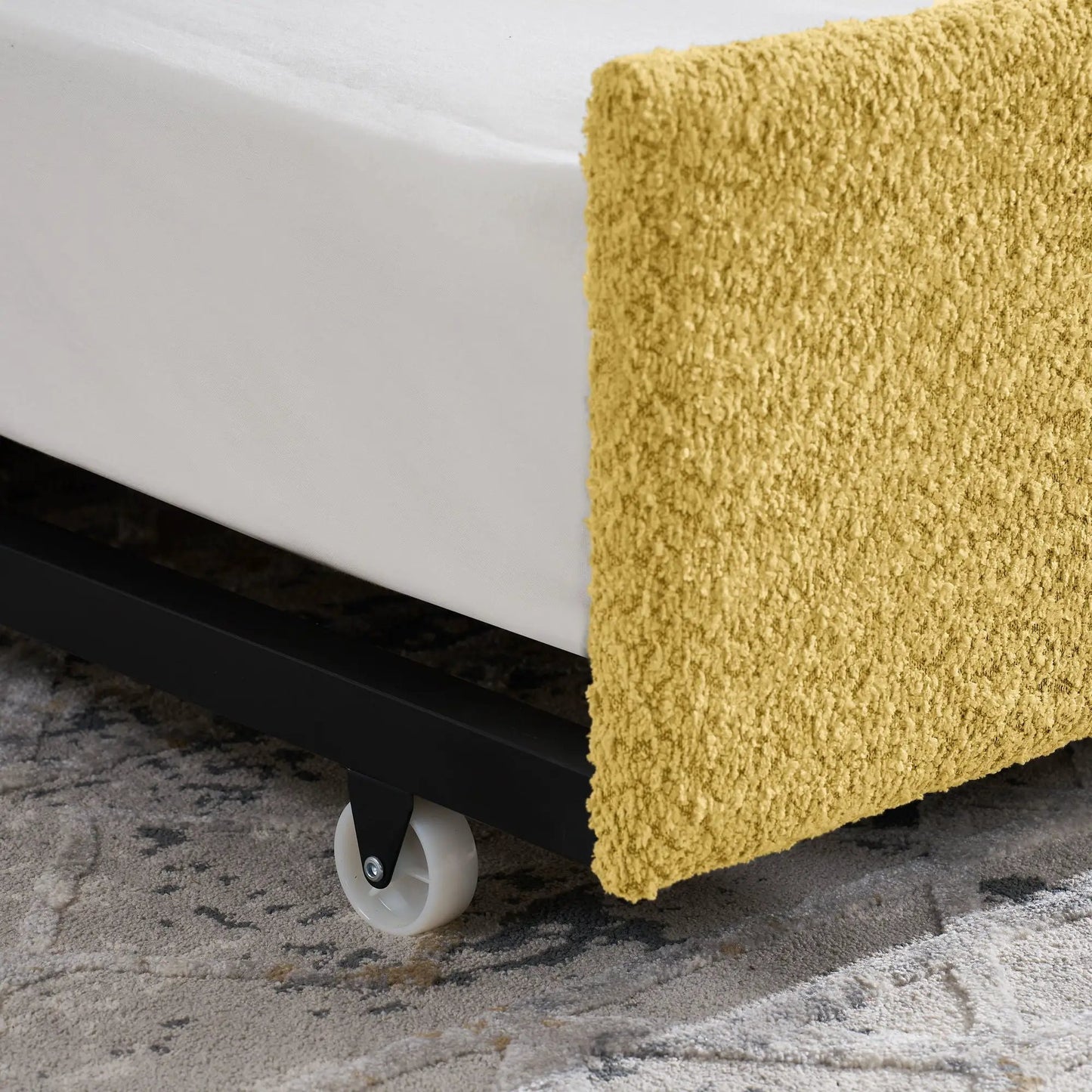 Upholstered daybed with pop-up trundle; black frame, white caster wheel, mustard yellow throw on Tampa Home & Garden Store