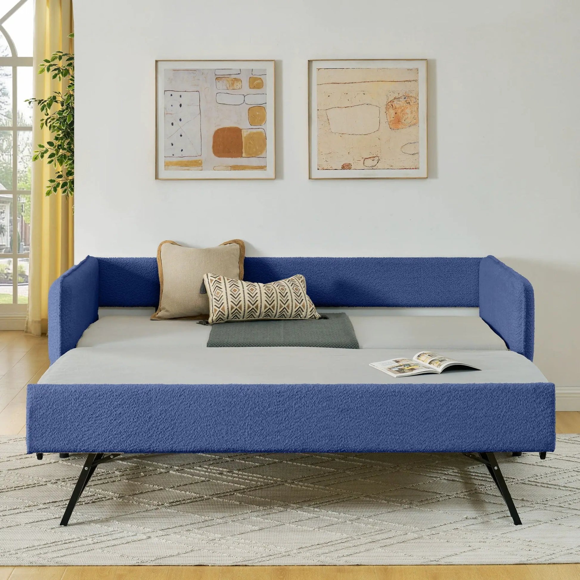 Upholstered daybed with pop up trundle in blue fabric, beige pillows on Tampa Home & Garden Store