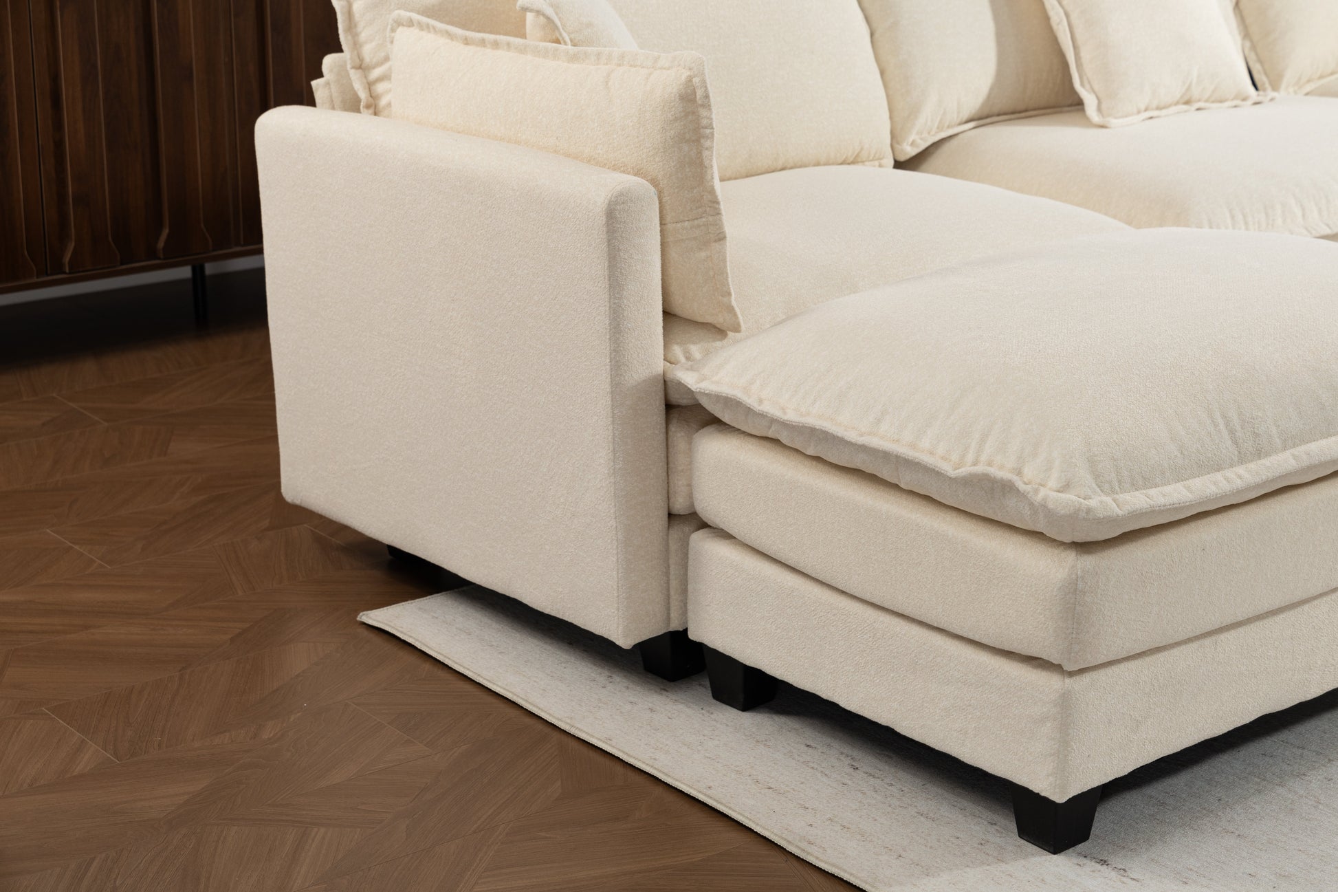Beige modern 4-seater sectional sofa with two ottomans, black legs on wood floor on Tampa Home & Garden Store