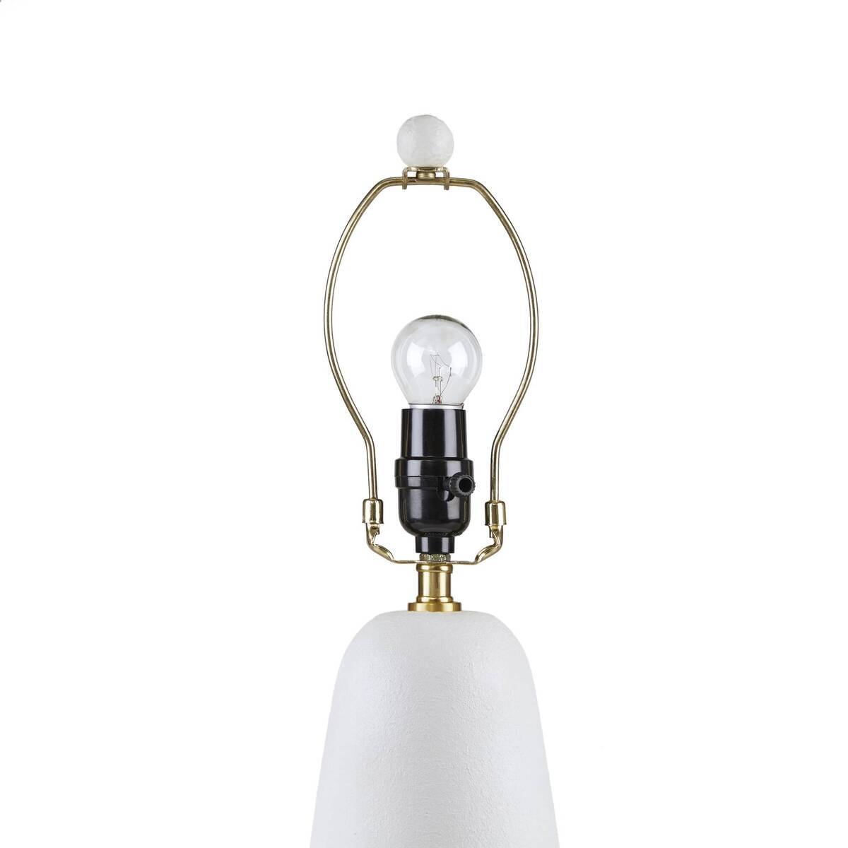 Textured white ceramic table lamp with brass arch frame, clear bulb, and white fluted shade on Tampa Home & Garden Store