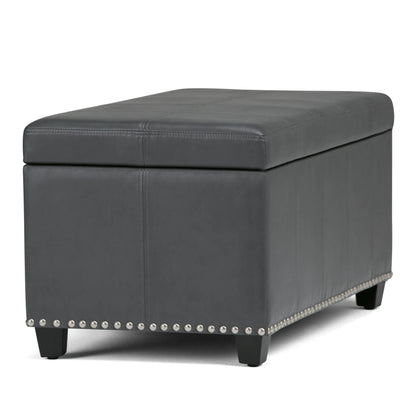 Amelia storage ottoman bench in gray faux leather with stitched top panels and studded base on Tampa Home & Garden Store