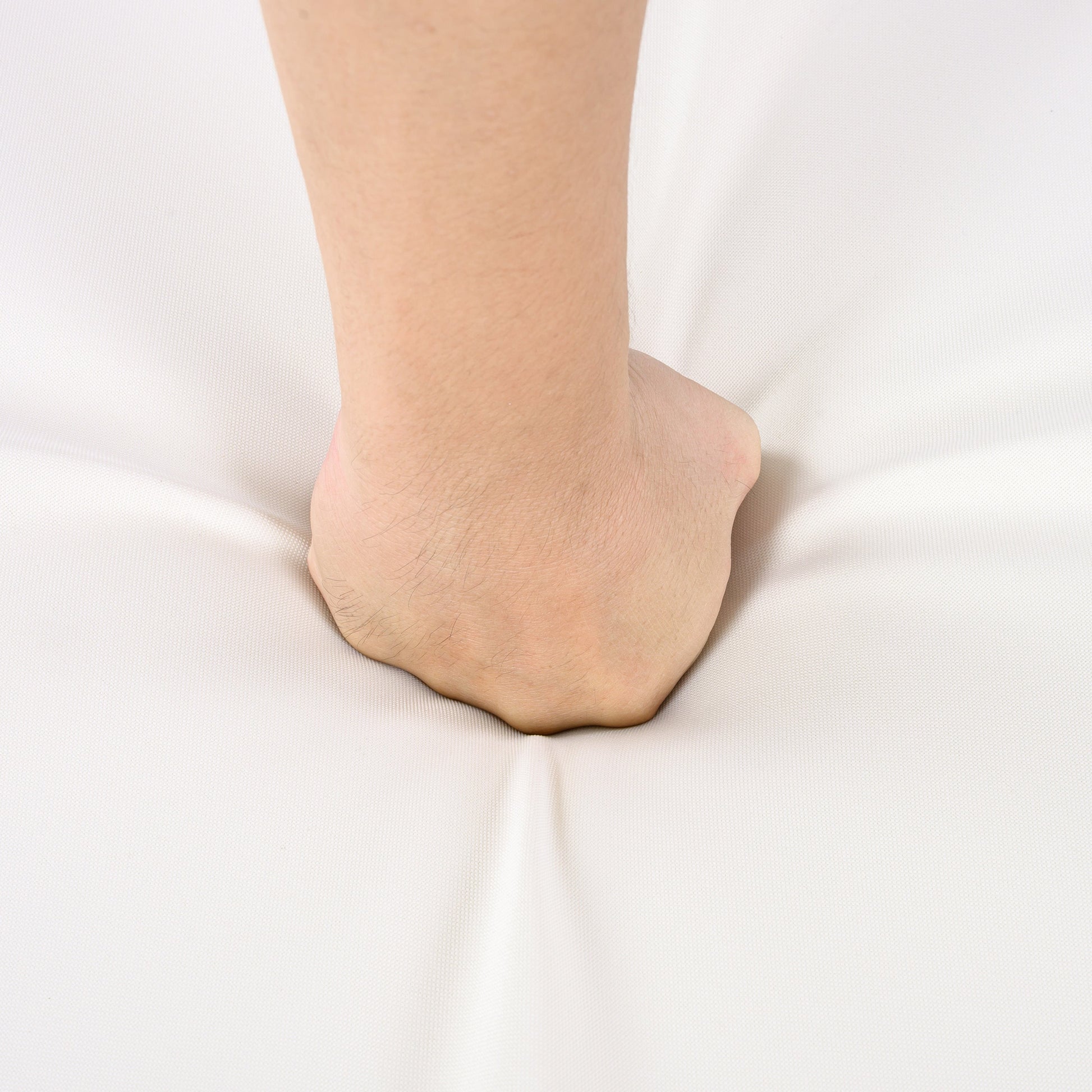 Bare ankle and lower leg close-up resting on white fabric background on Tampa Home & Garden Store