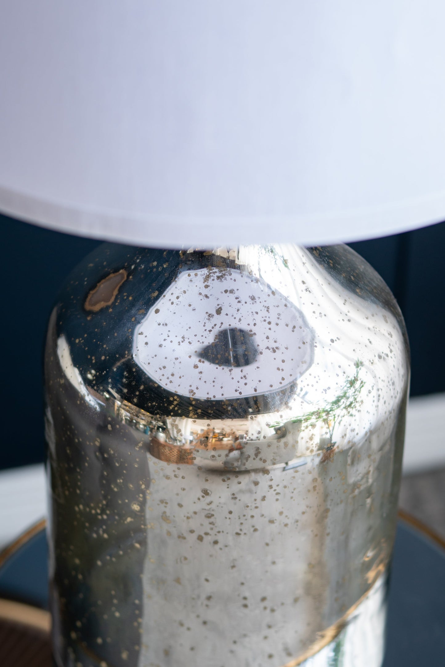 Silver round table lamp with white fabric shade and speckled metallic base on Tampa Home & Garden Store