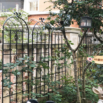 Black wrought-iron garden trellises with curved arch tops for climbing plants on Tampa Home & Garden Store