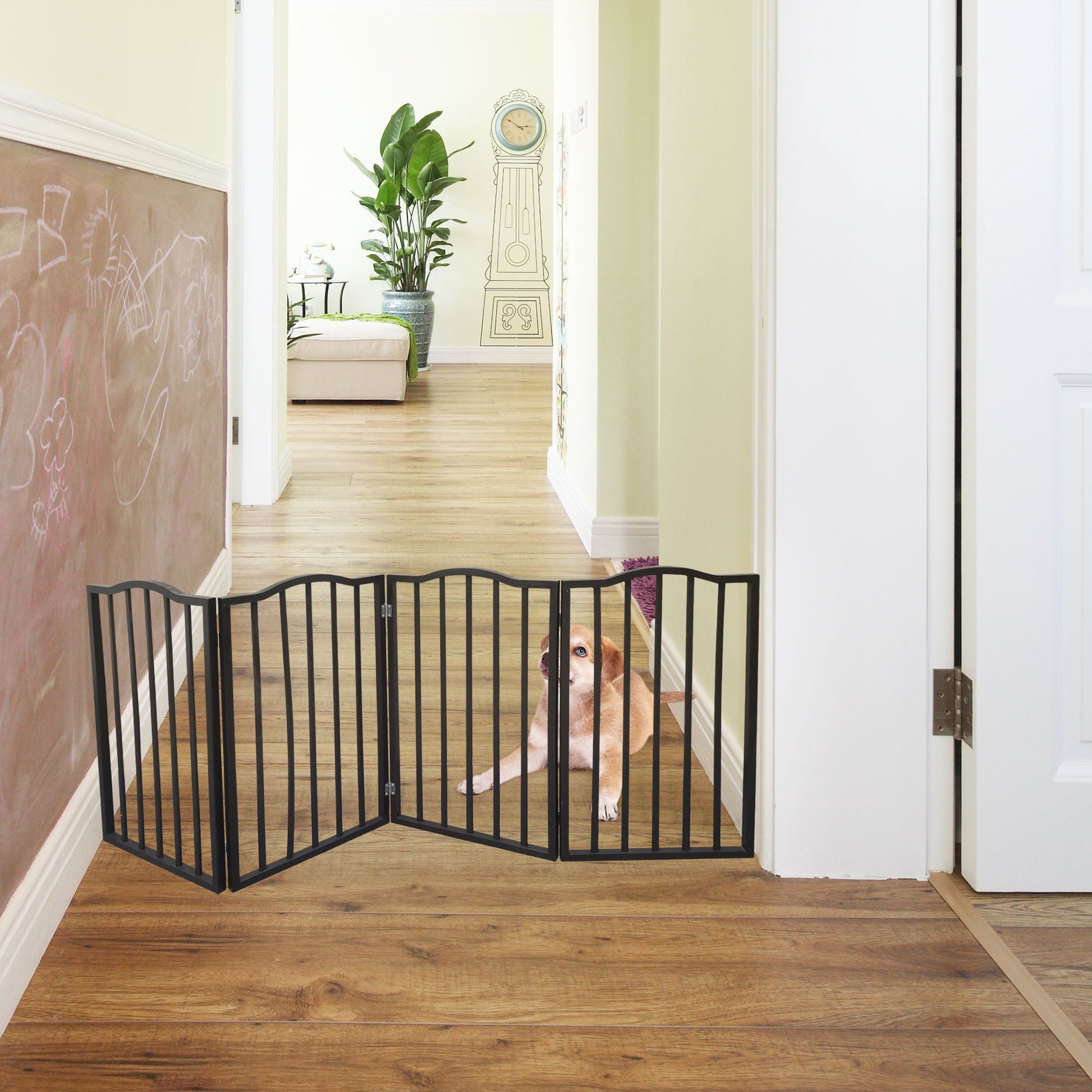 Dog gate dark brown metal barrier across hallway; dog peeks through, chalkboard wall behind on Tampa Home & Garden Store