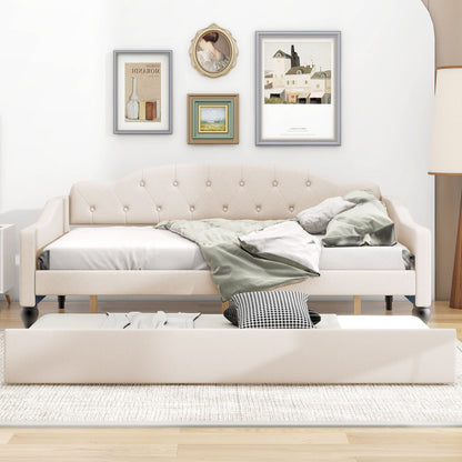 Upholstered tufted daybed in beige fabric with buttoned back and dark legs, wall art behind on Tampa Home & Garden Store