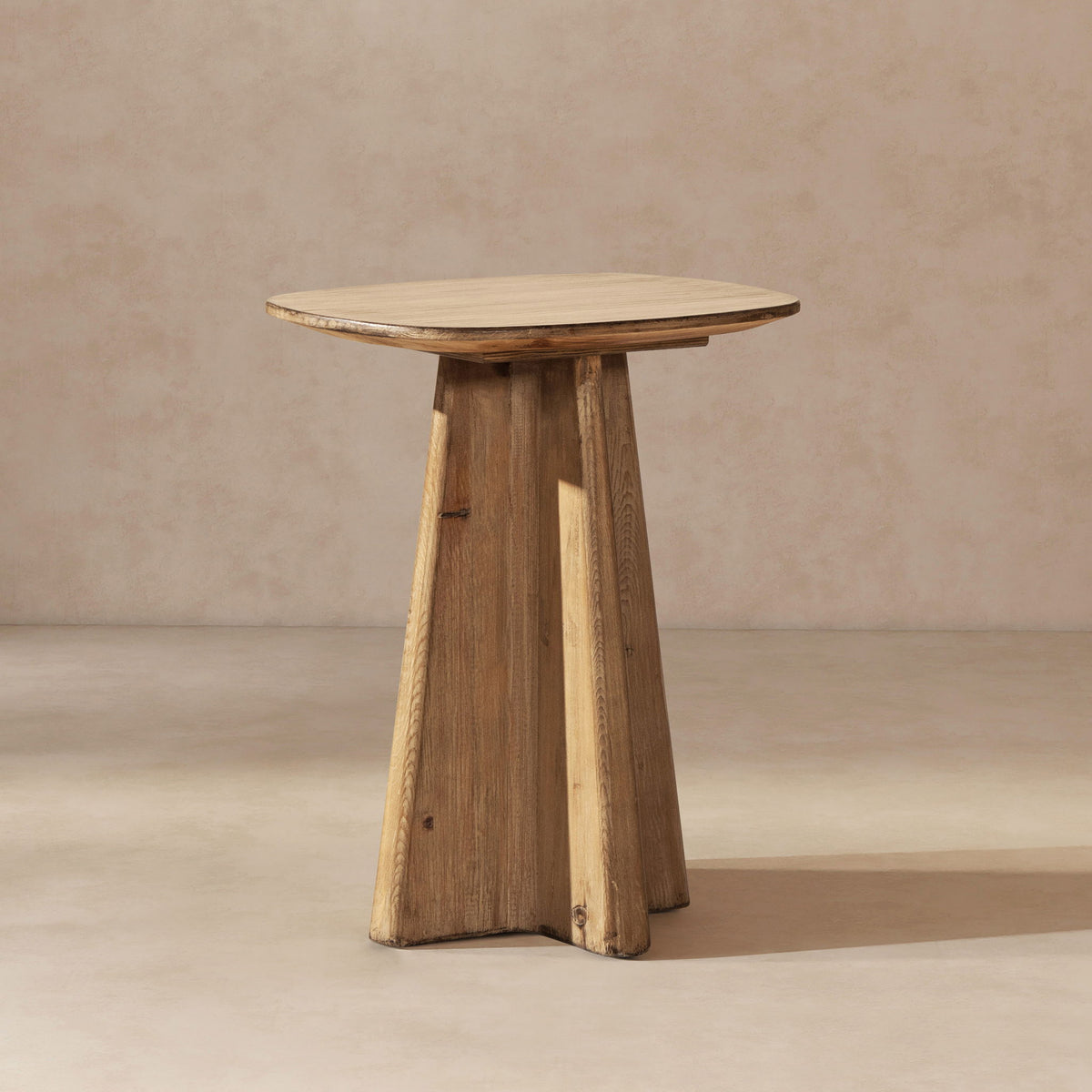End table in antique brown wood with a sculptural pedestal base and oval top on Tampa Home & Garden Store