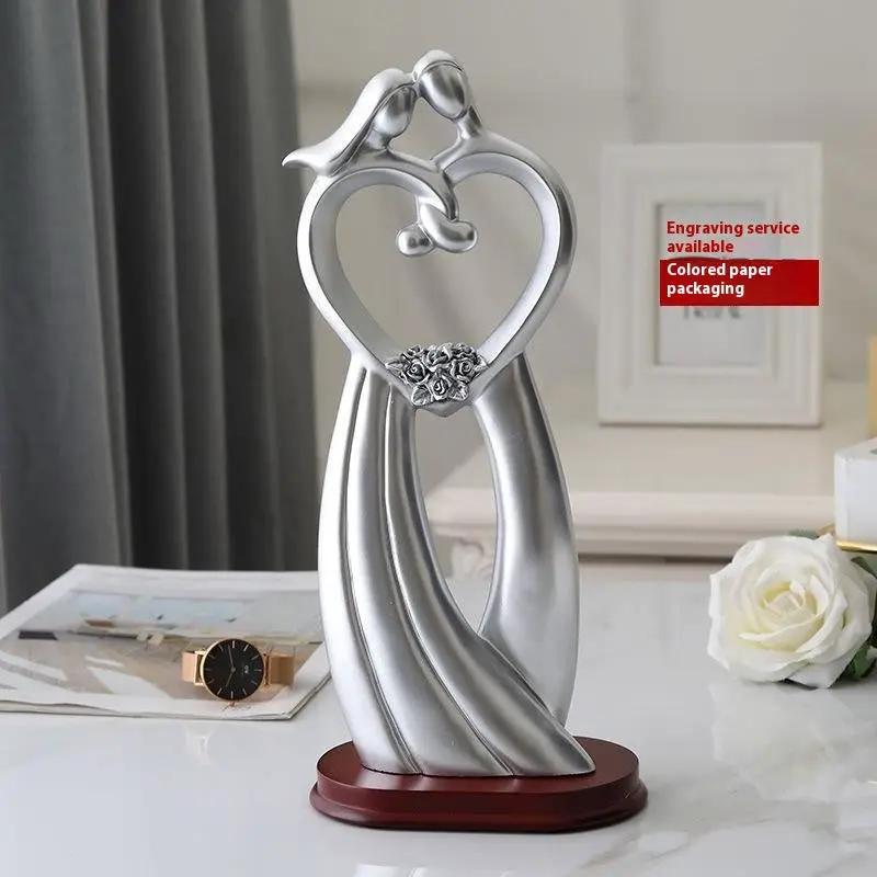 Silver-toned FLIPSTYLEZLLC couple statue with heart embrace atop a wooden base on Tampa Home & Garden Store