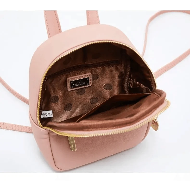 Pink mini soft-touch leather backpack by Stevvex with gold zipper and brown polka-dot lining on Tampa Home & Garden Store