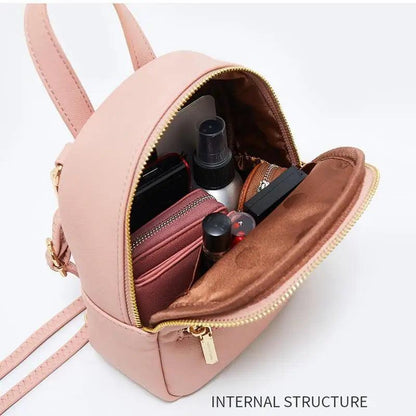 Pink mini soft-touch leather backpack opened to reveal makeup items and phone inside on Tampa Home & Garden Store