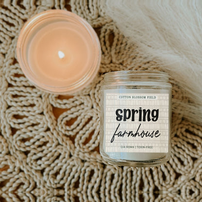 Cotton Blossom Candle Gia Roma in a clear glass jar with spring farmhouse label and warm glow on Tampa Home & Garden Store