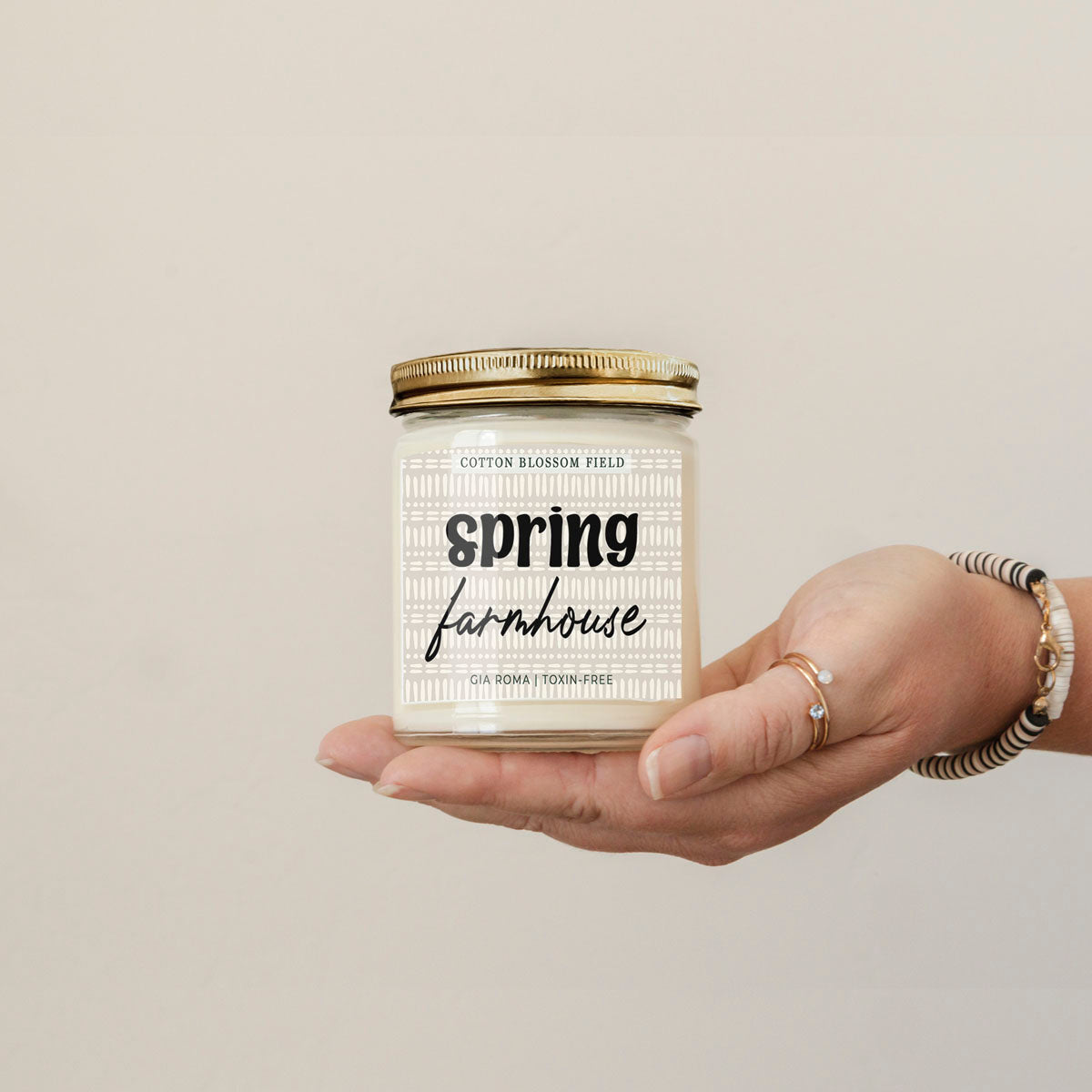 Cotton Blossom Candle by Gia Roma, white wax in a clear glass jar with a gold lid, farmhouse label on Tampa Home & Garden Store