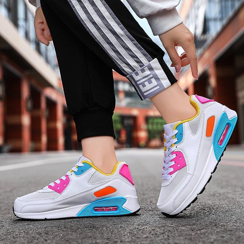 Stevvex athletic sneakers in white with pink, blue and yellow accents and visible air sole on Tampa Home & Garden Store