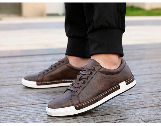 Pair of brown leather sneakers, lace-up casual footwear with white sole, walking shoes on Tampa Home & Garden Store