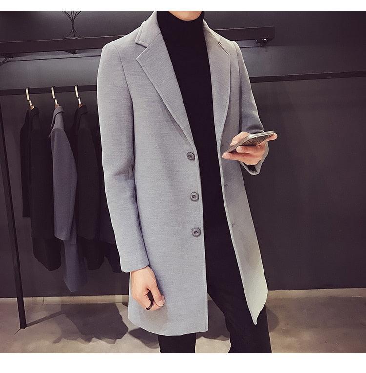 Stevvex men's gray trench coat with notch lapels and 3-button front over black turtleneck on rack visible in background on Tampa Home & Garden Store
