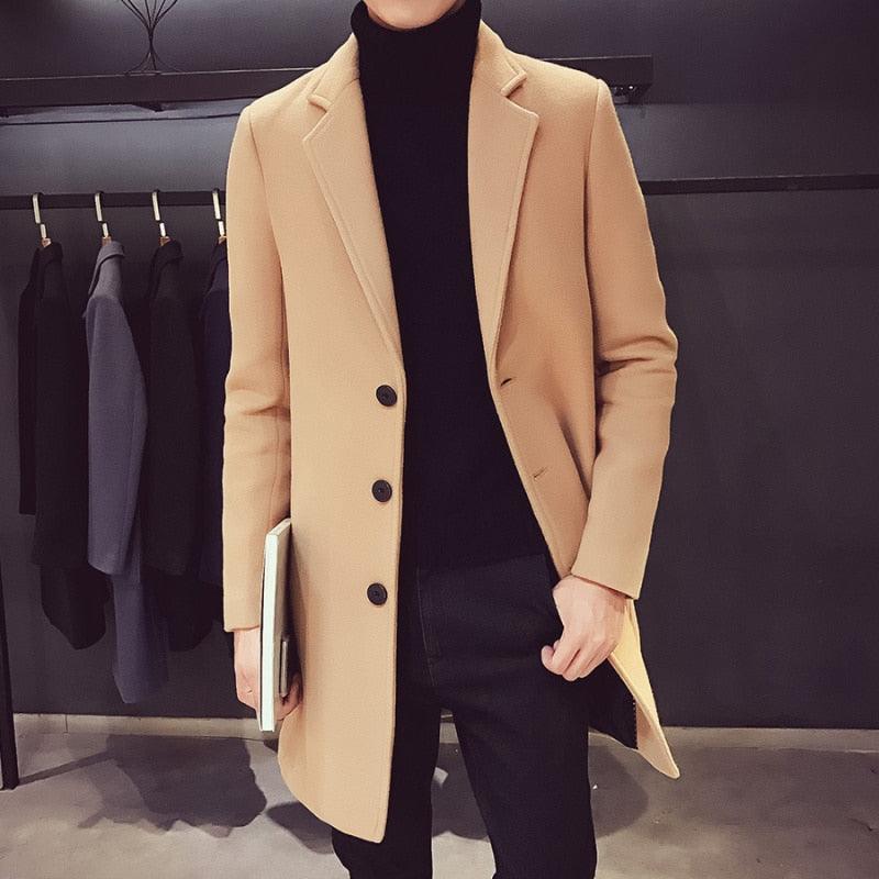 Men's camel trench coat by Stevvex, long with black buttons over black turtleneck on Tampa Home & Garden Store