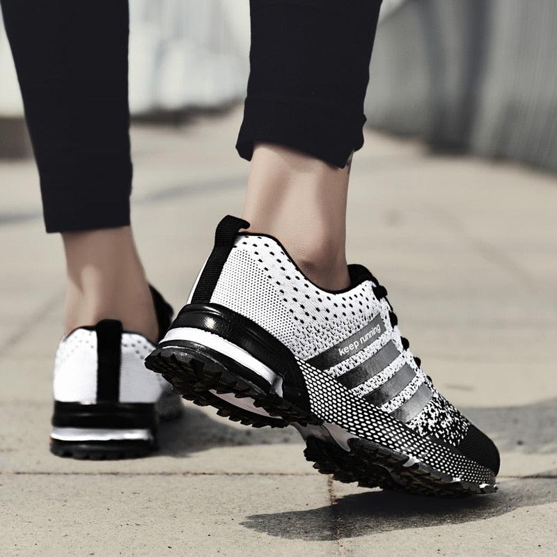 Stevvex unisex athletic sneakers pair white black breathable running shoes knit upper stripes on Tampa Home & Garden Store