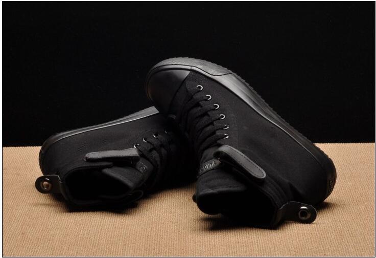 Two black high-top canvas sneakers with lace-up closure, rubber sole and back pull tabs on Tampa Home & Garden Store
