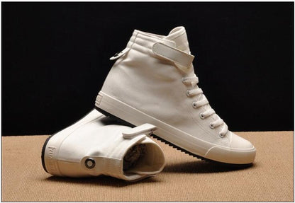 Pair of white canvas high-top sneakers with lace-up front and ankle strap, vulcanized sole on Tampa Home & Garden Store