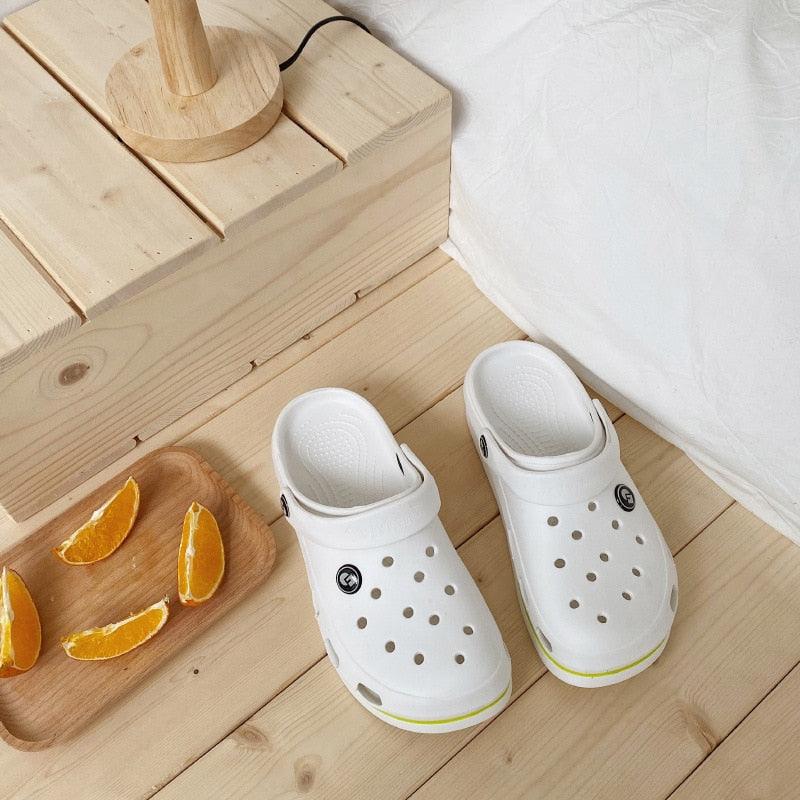 Stevvex Womens Soft EVA Clogs white non-slip beach slippers, pair on light wood floor on Tampa Home & Garden Store