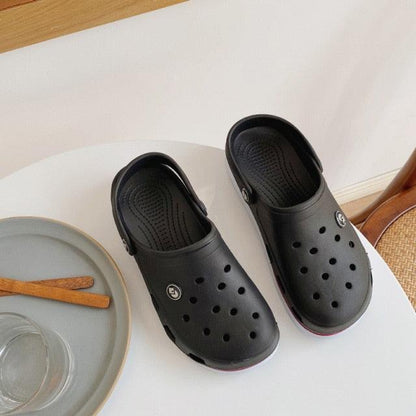 Stevvex womens soft EVA clogs in black, non-slip beach slides pair on table on Tampa Home & Garden Store