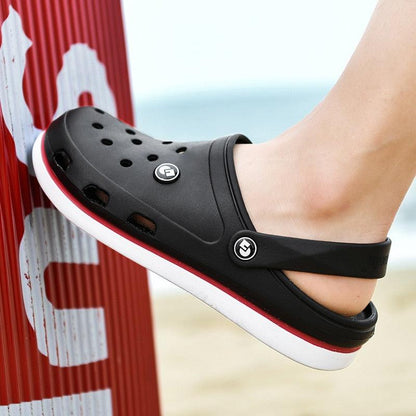 Stevvex men's black ankle-wrap clog slippers with perforated upper and logo buttons on beach on Tampa Home & Garden Store