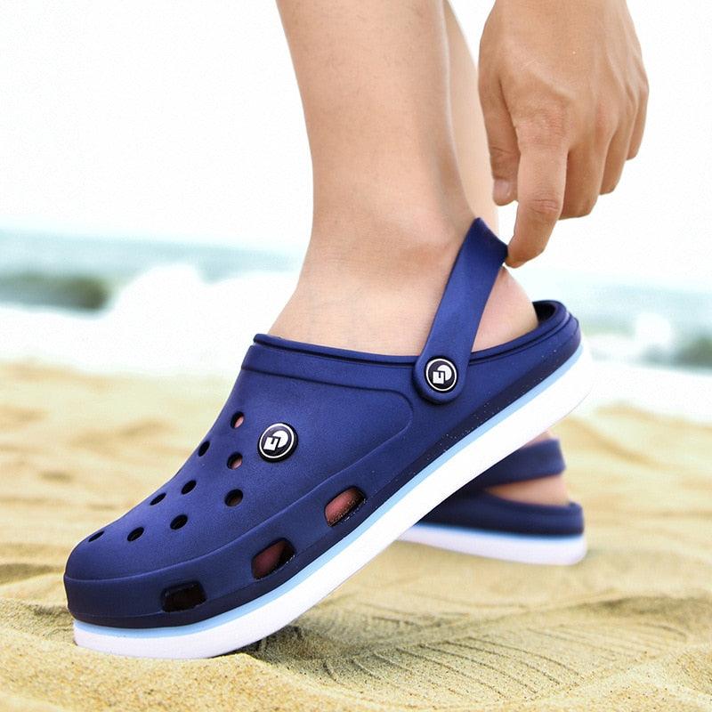 Stevvex men's blue ankle-wrap clogs with breathable holes and white sole on beach on Tampa Home & Garden Store
