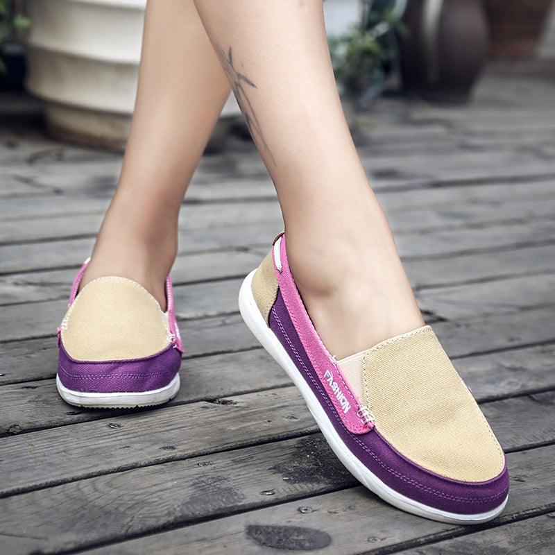 Pair of women’s slip-on espadrille flats in beige canvas with purple trim and white sole on Tampa Home & Garden Store