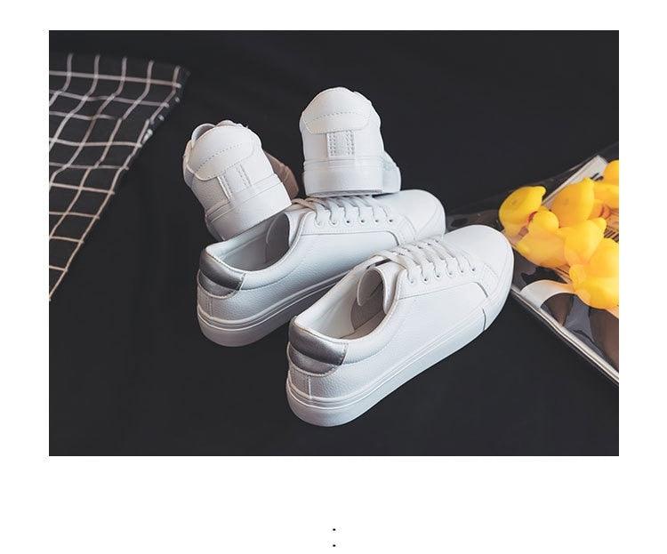Four white leather vulcanized sneakers for women, casual low-top lace-up on dark backdrop on Tampa Home & Garden Store