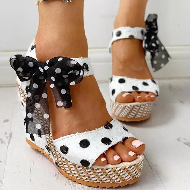 Stevvex women's wedge sandals pair with white polka dot straps and a black bow on the ankle on Tampa Home & Garden Store