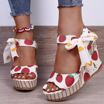 Stevvex strawberry-print sandals pair with white fabric, bow ankle ties, woven jute platform on Tampa Home & Garden Store