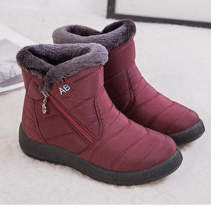Pair of burgundy fur-lined waterproof winter boots with side zip on Tampa Home & Garden Store