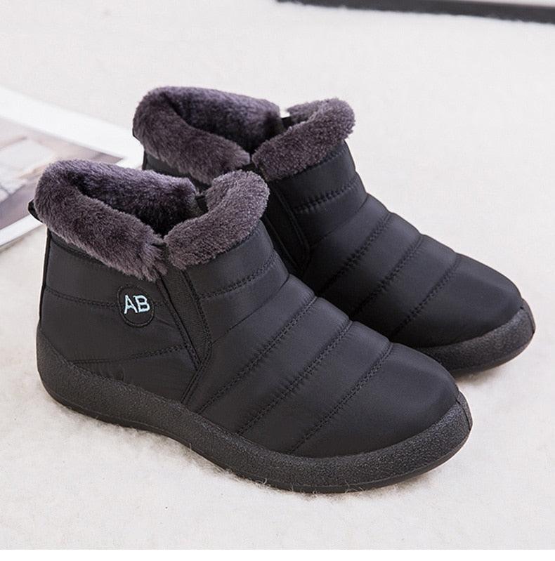 Pair of Stevvex black waterproof ankle boots with AB logo, fur lining, slip-on winter booties on Tampa Home & Garden Store