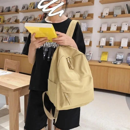 Stevvex beige laptop backpack with top handle and front pockets carried by teen in a bookstore on Tampa Home & Garden Store