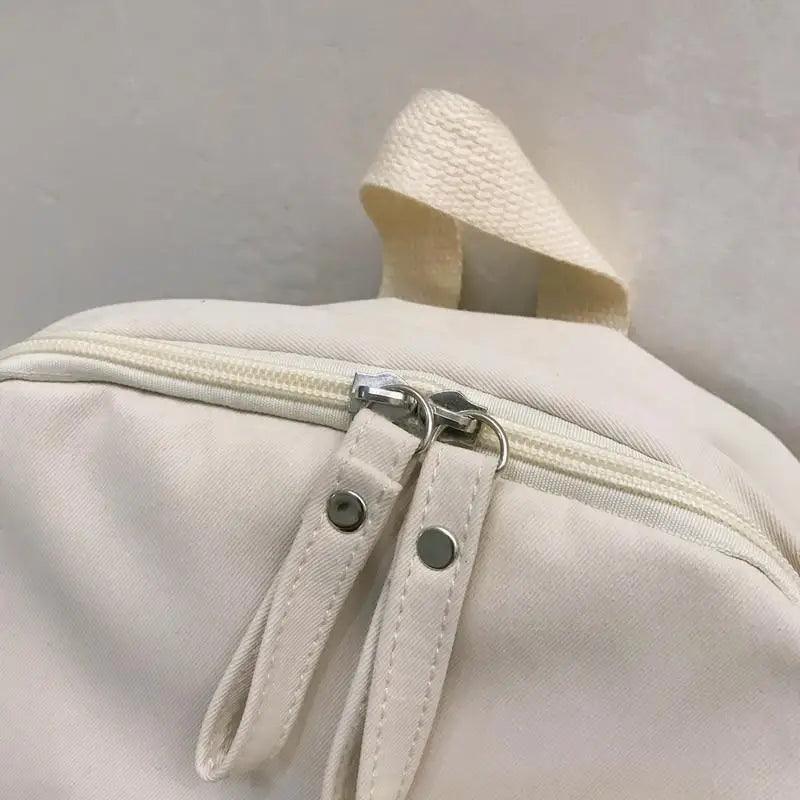 Laptop backpack Stevvex white canvas with dual zipper pulls and top grab handle on Tampa Home & Garden Store