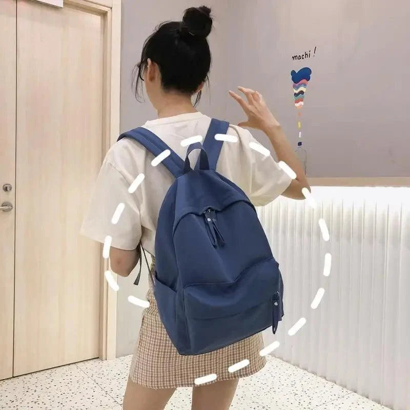 Blue solid-color laptop backpack with front zip pocket for teens on Tampa Home & Garden Store