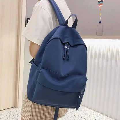 Stevvex laptop backpack navy blue solid color with front zip pocket carried by teen girl on Tampa Home & Garden Store