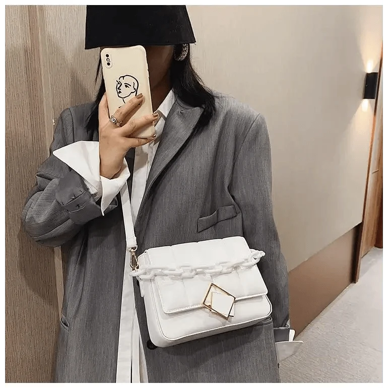 White quilted crossbody shoulder bag with chunky chain detail and geometric gold clasp on Tampa Home & Garden Store