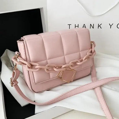 Pink quilted women's shoulder bag with a chunky chain strap cross-body design on Tampa Home & Garden Store